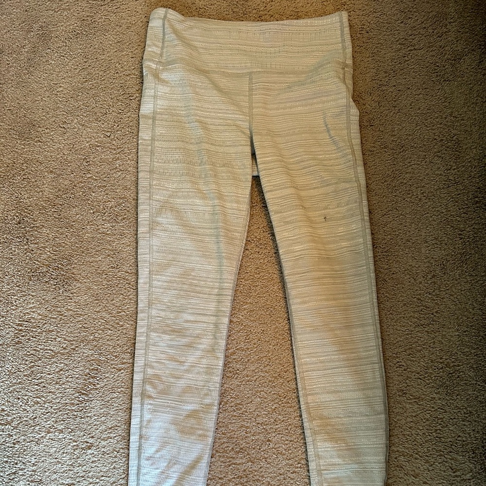 Medium athleta leggings with a small hole in the thigh